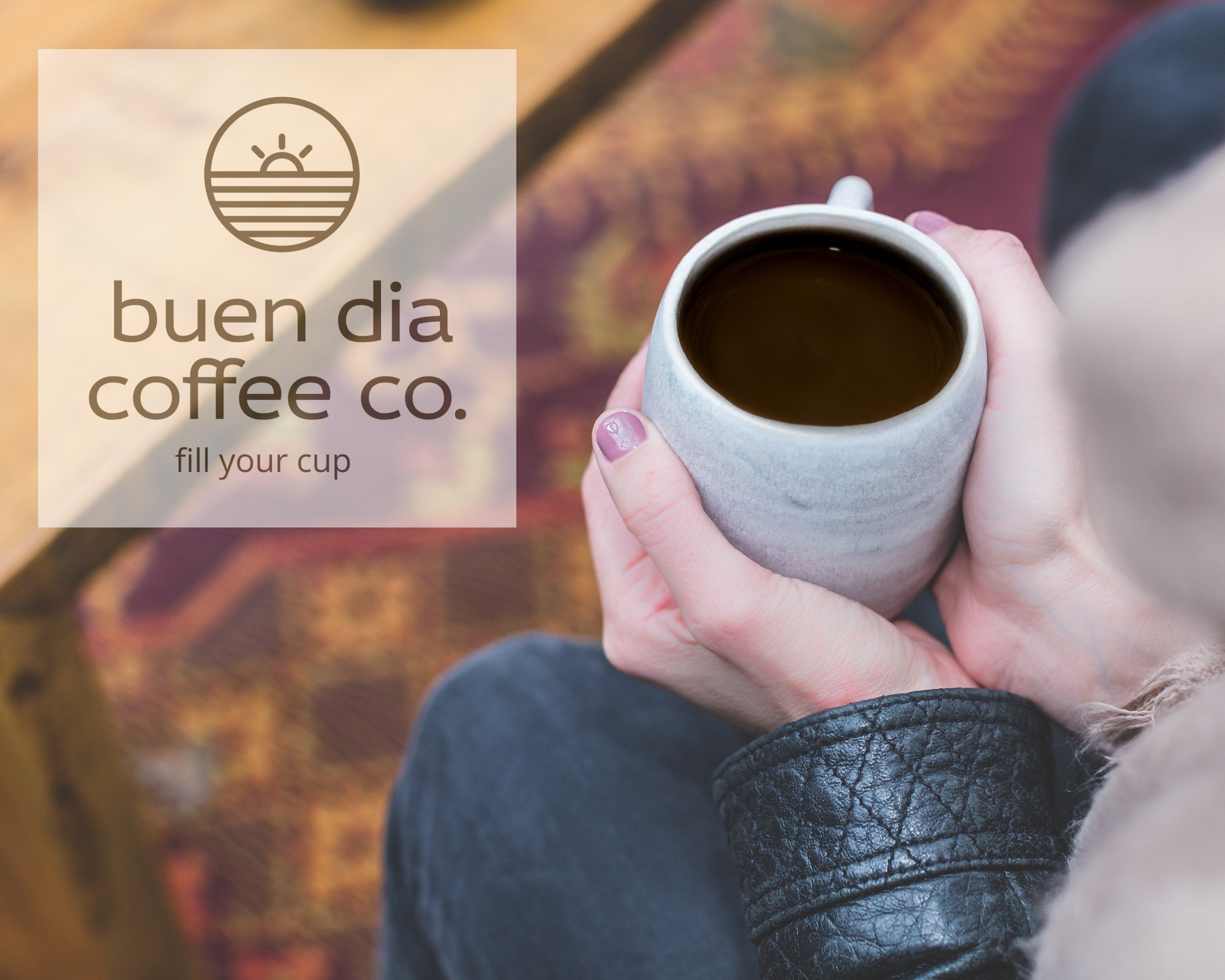Person holding a coffee cup with 'buen dia coffee co.' logo in the corner.