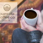Person holding a coffee cup with 'buen dia coffee co.' logo in the corner.