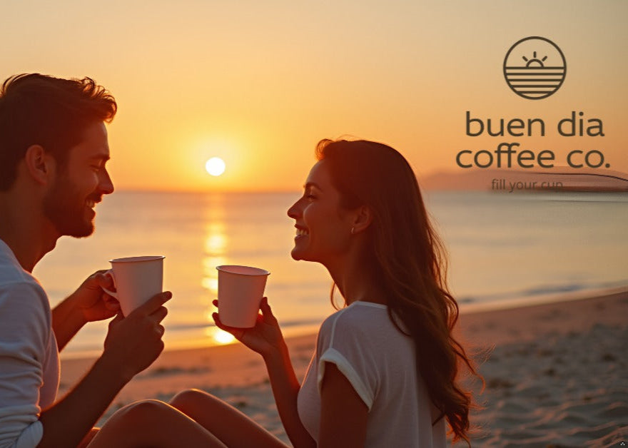 Couple enjoying coffee on a beach at sunset with 'buen dia coffee co.' logo.