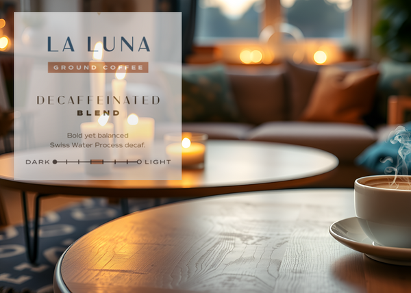 La Luna decaffeinated blend coffee package with a steaming cup of coffee on a table in a cozy living room.